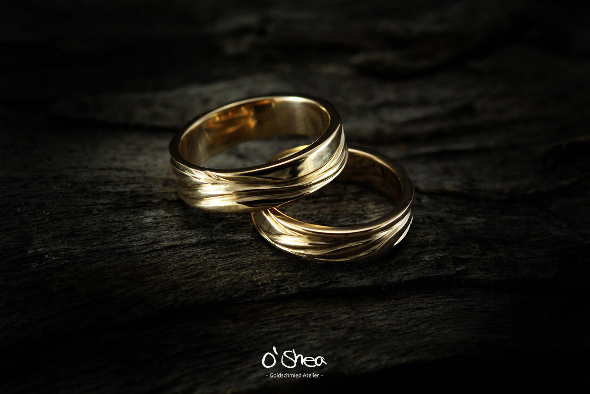 Wedding Rings: engraved lines represent the flow through love and life